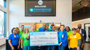 Amerigroup DC presents DCCK CEO Mike Curtin with $80,000 donation for Culinary Job Training program.