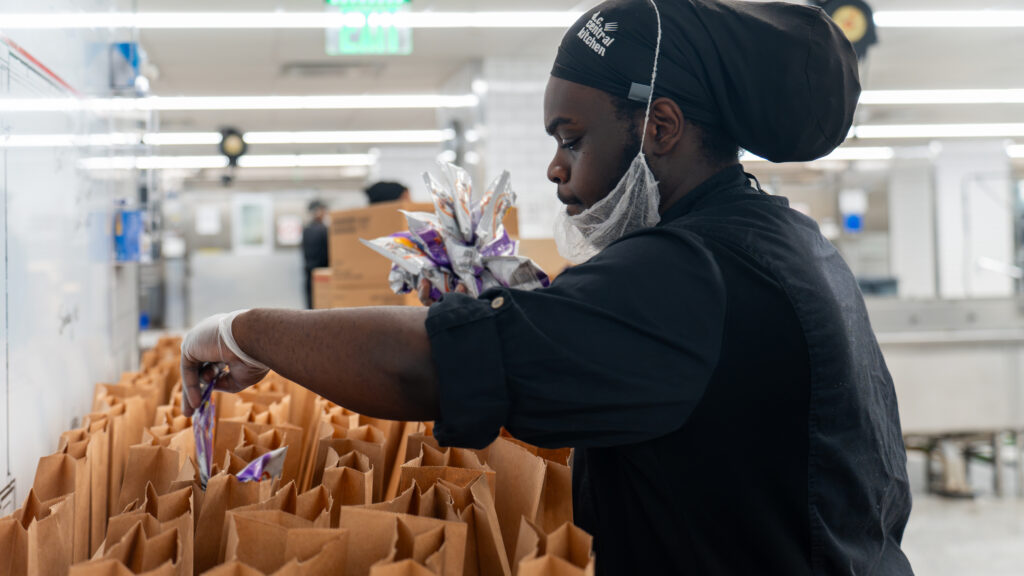 A DC Central Kitchen worker prepares meals for distribution.