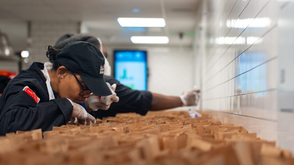 A DC Central Kitchen worker prepares meals for distribution.