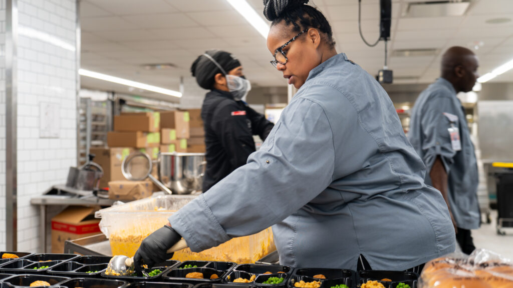 A DC Central Kitchen worker packages meals for the first responders of the Potomac River mid-air collision. 