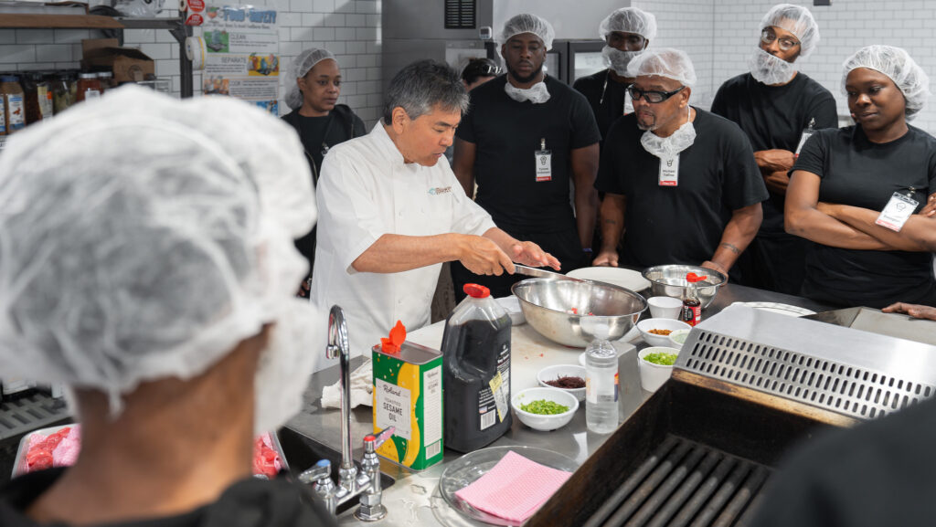 Chef Roy Yamaguchi leading a poke demo for CJT Class 175