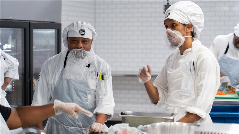 Joseph with classmate Terrence in the Culinary Job Training kitchen