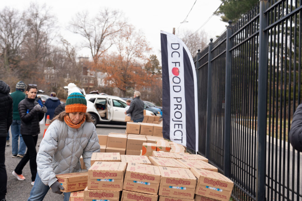 A volunteer at a December 2024 DC Food Project distribution 
