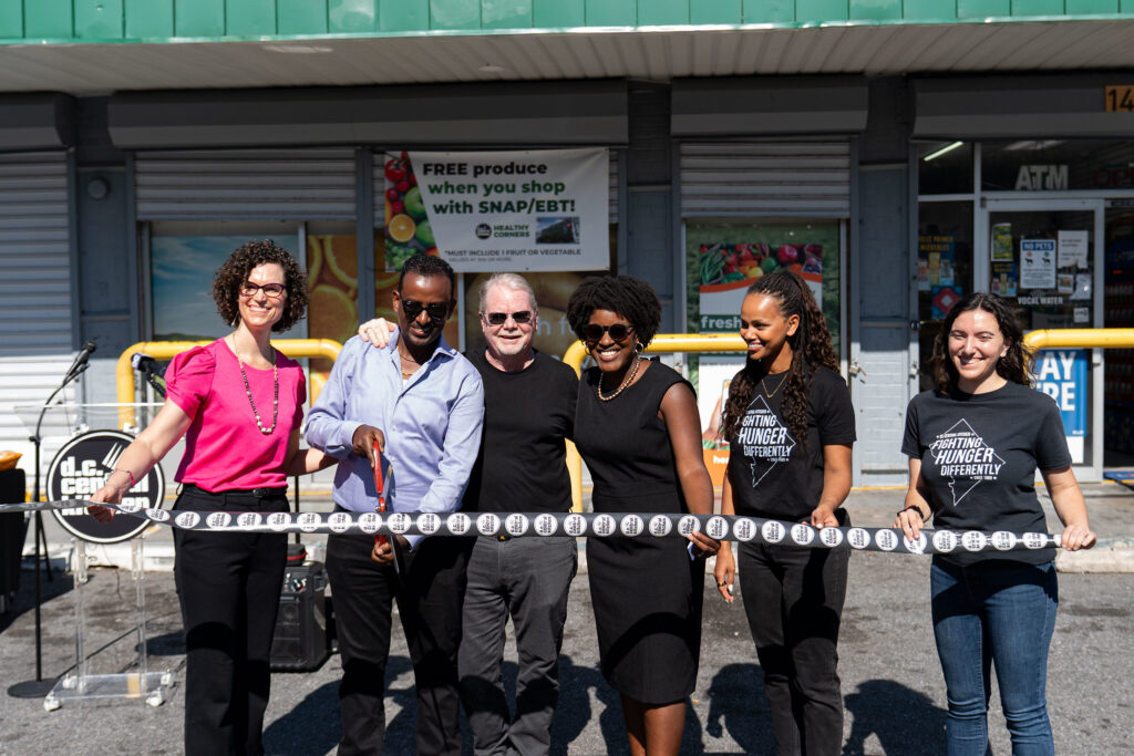 Sara Beckwith (DC Health Senior Deputy Director of the Community Health Administration), Yonas Haile (Stanton Supermarket Owner), Mike Curtin (DC Central Kitchen CEO), Christina Henderson (DC Councilmember At-Large), Kapi Berhanu (Healthy Corners Program Manager), Yael Reichler (Healthy Corners Director) at the Stanton Supermarket produce department ribbon cutting