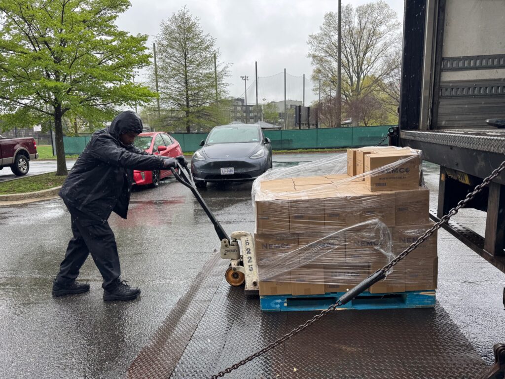 A DC Central Kitchen worker unloading a truck for DC Food Project
