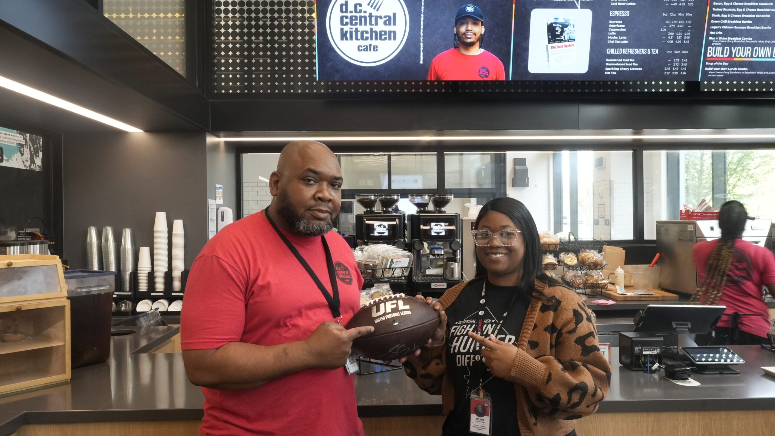 DC Central Kitchen employees holding a UFL football