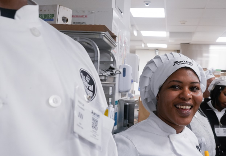 A smiling DC Central Kitchen student