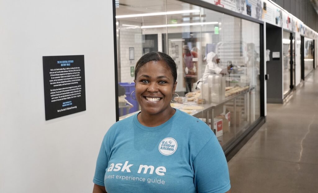 A smiling DC Central Kitchen worker