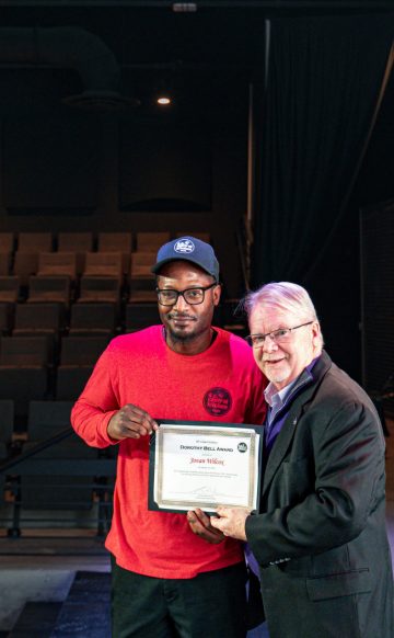 DC Central Kitchen Cafe Employee Jovan receiving an award on stage