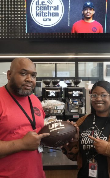 DC Central Kitchen employees holding a UFL football